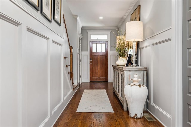 entryway with crown molding and dark hardwood / wood-style flooring