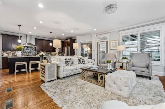 living room with ornamental molding and dark hardwood / wood-style flooring