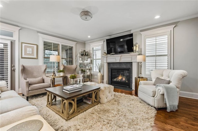 living room with a fireplace, ornamental molding, and dark hardwood / wood-style floors