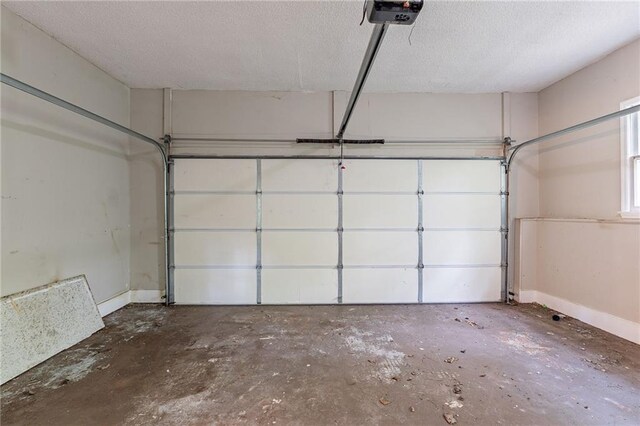 402 John Tate Rd NW, Acworth, GA 30102 - garage featuring a garage door opener and baseboards