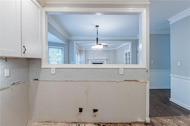 402 John Tate Rd NW, Acworth, GA 30102 - kitchen featuring white cabinets, ornamental molding, dark wood-type flooring, tasteful backsplash, and pendant lighting