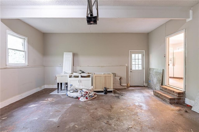 402 John Tate Rd NW, Acworth, GA 30102 - garage featuring a garage door opener and baseboards