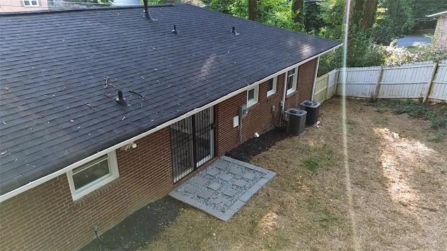 257 E Simon Ter NW, Atlanta, GA 30318 - back of house with brick siding, a shingled roof, and a fenced backyard