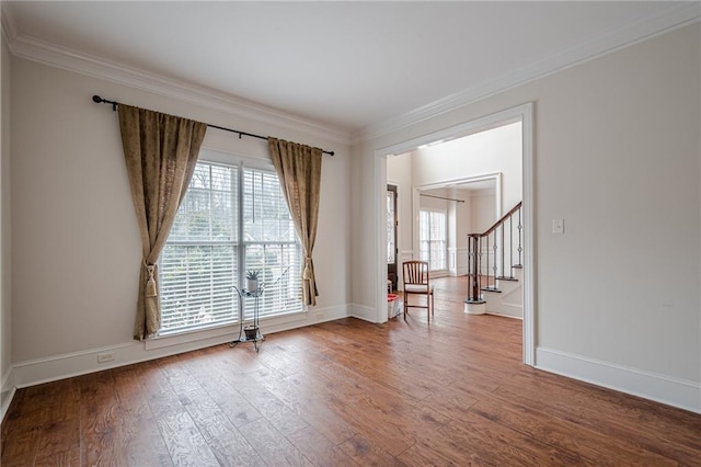 spare room with crown molding and hardwood / wood-style floors