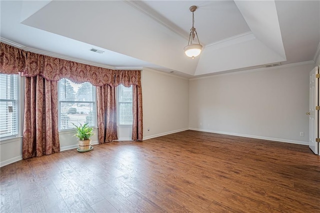 unfurnished room featuring hardwood / wood-style flooring, crown molding, and a tray ceiling