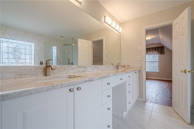 bathroom featuring vanity and an enclosed shower