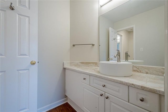 bathroom with vanity and hardwood / wood-style floors