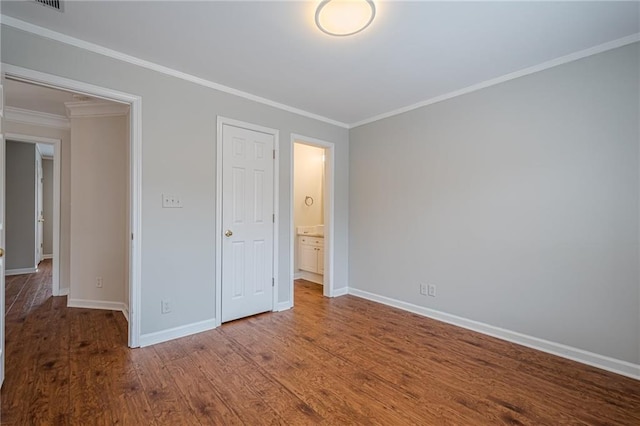 unfurnished bedroom featuring crown molding, hardwood / wood-style floors, and a closet