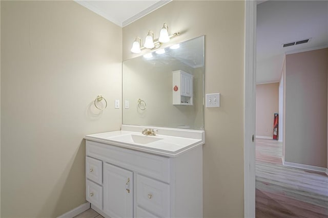 bathroom featuring crown molding and vanity