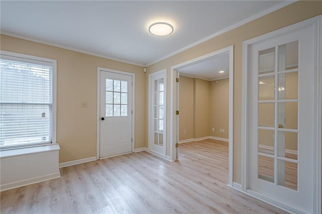 foyer featuring crown molding and light hardwood / wood-style flooring