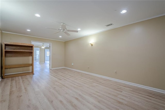 spare room featuring crown molding, ceiling fan, and light hardwood / wood-style flooring