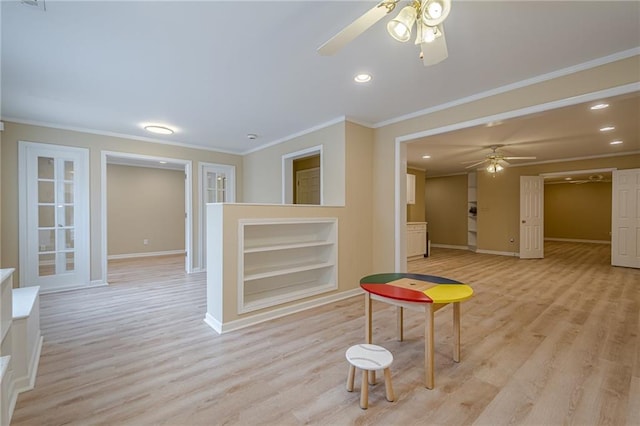 interior space with crown molding, built in shelves, light hardwood / wood-style flooring, and ceiling fan