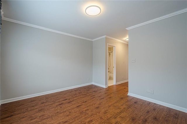 empty room with hardwood / wood-style flooring and crown molding