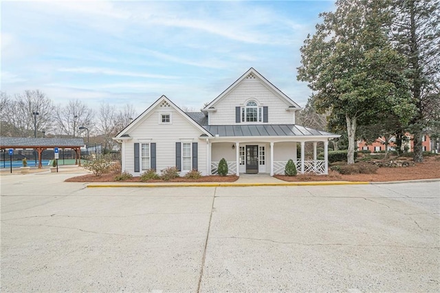 view of front of house featuring a porch and a carport