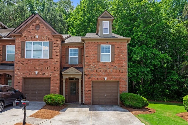view of front facade with driveway, a garage, and brick siding