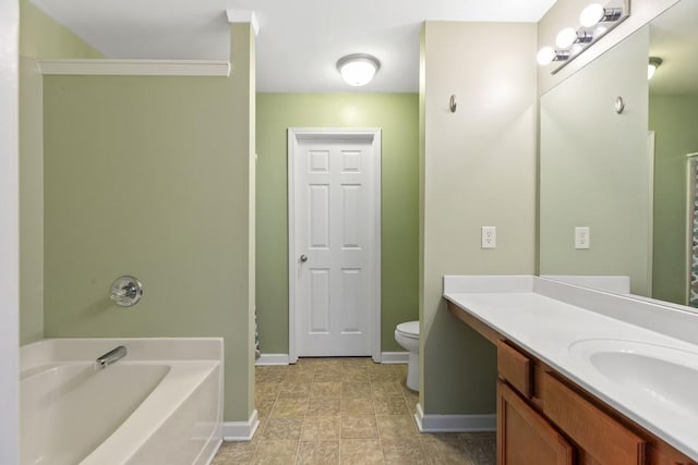 bathroom featuring baseboards, a bath, toilet, vanity, and tile patterned floors