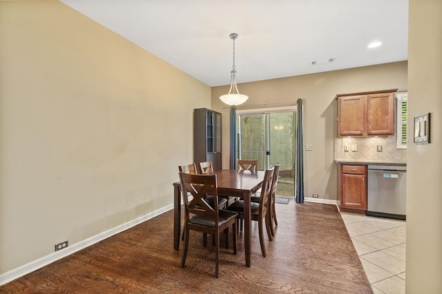 dining room featuring baseboards, light wood-style flooring, and recessed lighting