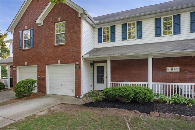 210 Cottonwood Creek Cir, Canton, GA 30114 - traditional-style house featuring covered porch, driveway, a garage, and brick siding