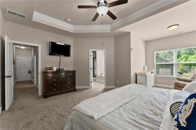 bedroom with visible vents, crown molding, a raised ceiling, baseboards, and carpet floors