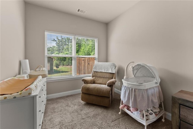 sitting room with visible vents, baseboards, and light carpet