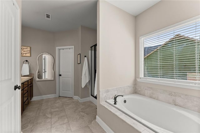 bathroom featuring a bath, visible vents, a stall shower, vanity, and baseboards