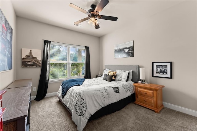 carpeted bedroom featuring baseboards, a ceiling fan, and visible vents