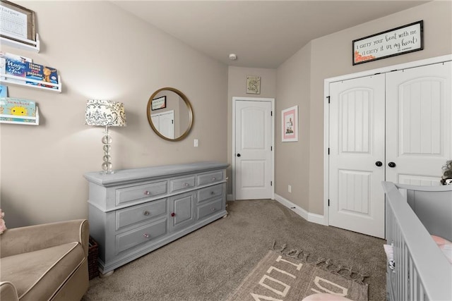 carpeted bedroom featuring a closet and baseboards