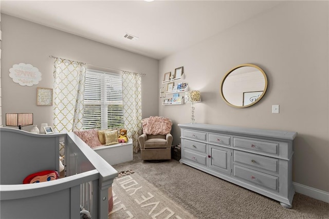 bedroom with baseboards, visible vents, and light colored carpet