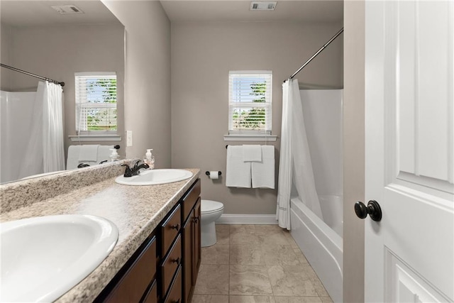 bathroom with visible vents, a sink, and a healthy amount of sunlight