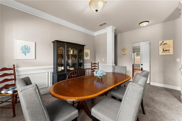 dining space featuring visible vents, ornamental molding, decorative columns, carpet floors, and wainscoting