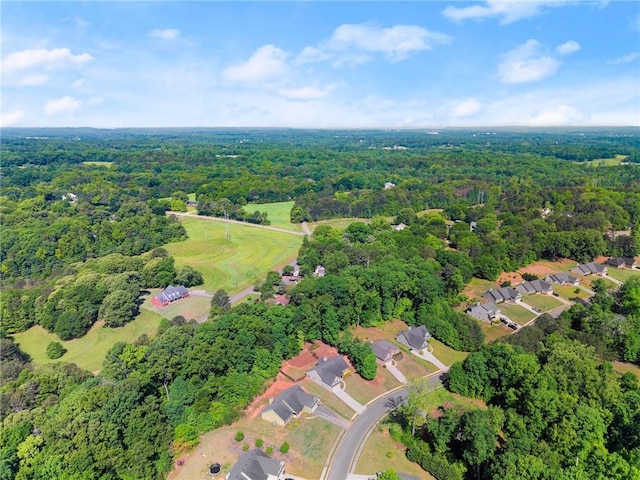 birds eye view of property featuring a residential view and a wooded view