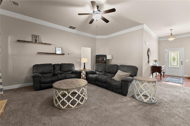 carpeted living area featuring visible vents, crown molding, baseboards, and ceiling fan