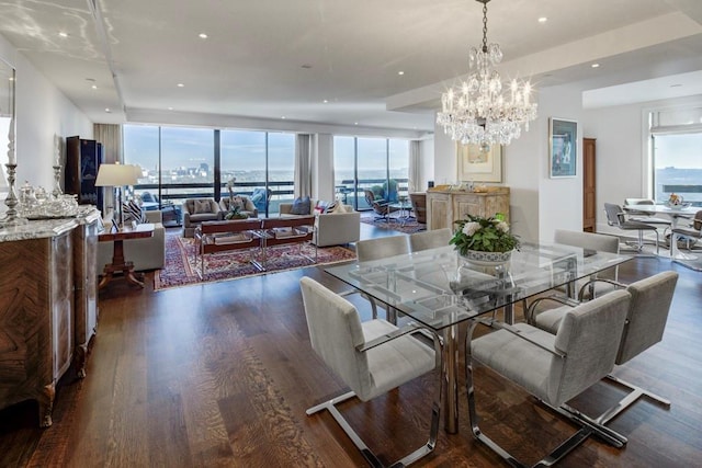 dining area with dark wood-type flooring, a wall of windows, and a chandelier