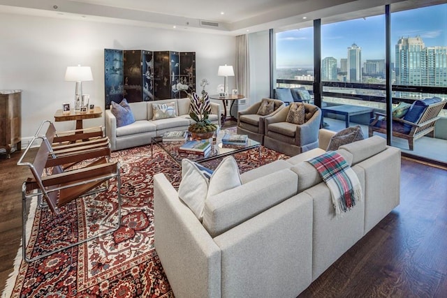 living room with dark hardwood / wood-style flooring and floor to ceiling windows