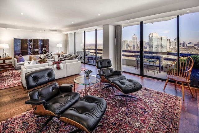 living room featuring floor to ceiling windows, a wealth of natural light, and hardwood / wood-style floors