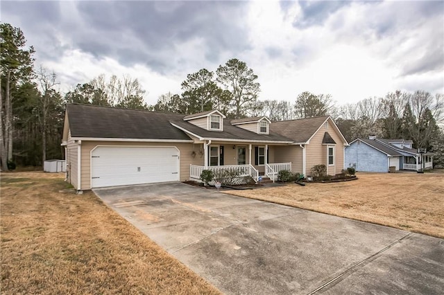 view of front of house with a porch, a front yard, driveway, and an attached garage