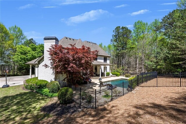 921 Accipiter Way, Ball Ground, GA 30107 - rear view of property with a patio area and a chimney