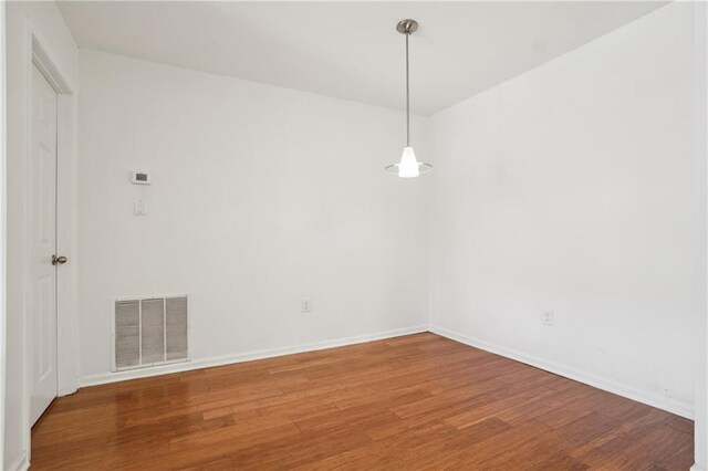 spare room with hardwood / wood-style floors