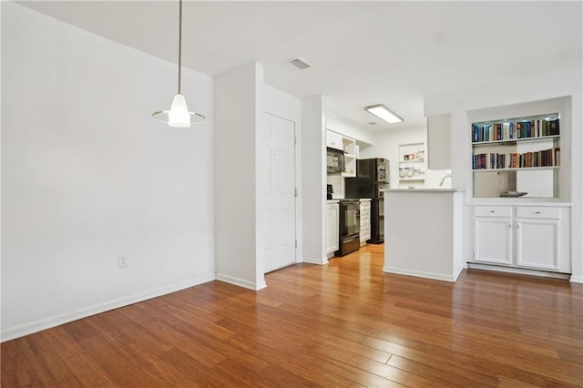 unfurnished living room featuring wood-type flooring