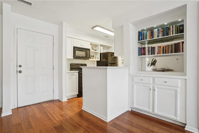 kitchen featuring decorative backsplash, light hardwood / wood-style flooring, black appliances, and white cabinets