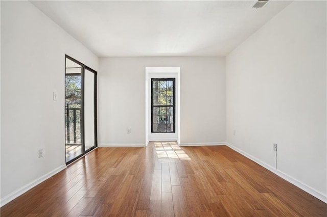 spare room featuring wood-type flooring