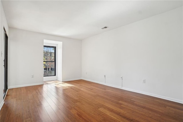 empty room featuring hardwood / wood-style flooring