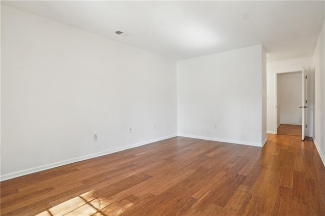 spare room with hardwood / wood-style floors