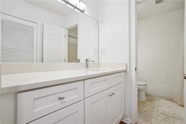 bathroom with vanity and toilet