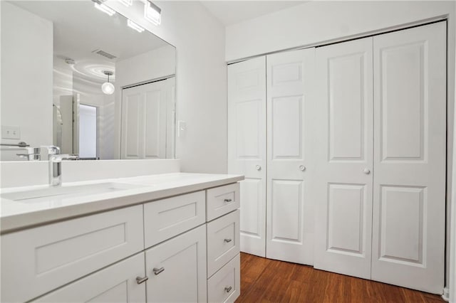 bathroom with vanity and hardwood / wood-style floors