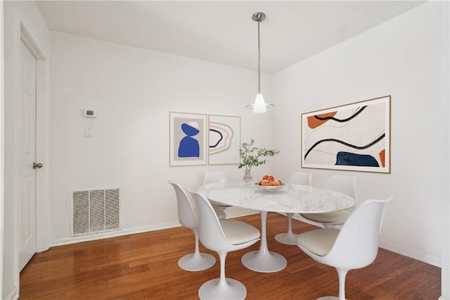 dining space with hardwood / wood-style floors