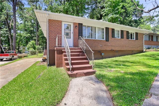 2215 Springdale Rd SW, Atlanta, GA 30315 - view of front facade featuring crawl space, a front lawn, brick siding, and concrete driveway