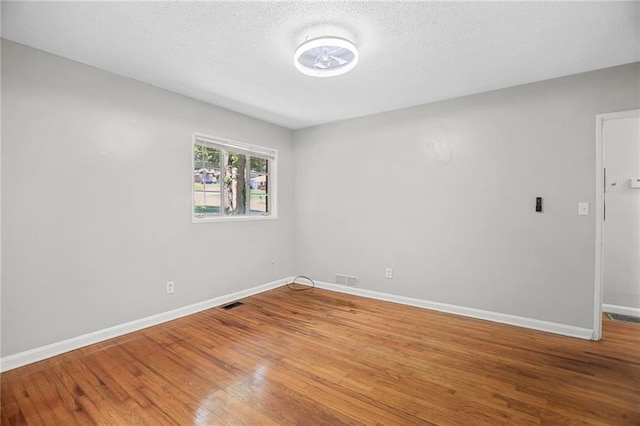 2215 Springdale Rd SW, Atlanta, GA 30315 - empty room with wood finished floors, baseboards, and a textured ceiling