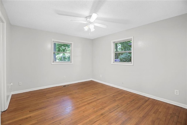2215 Springdale Rd SW, Atlanta, GA 30315 - unfurnished room with hardwood / wood-style floors, baseboards, a textured ceiling, and a ceiling fan