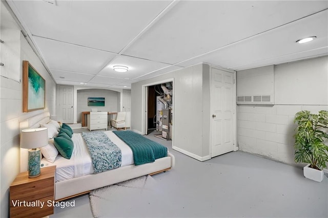 2215 Springdale Rd SW, Atlanta, GA 30315 - bedroom featuring finished concrete flooring, concrete block wall, and a closet